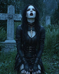 GRID THUMBNAIL — Gothic woman in black leather kneels in a moonlit graveyard before a stone cross, wearing chains, gloves, and silver cross necklaces.