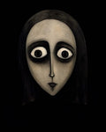 GRID THUMBNAIL — Surreal gothic portrait of an androgynous human face with huge dark-rimmed eyes and pursed lips, emerging from a pitch-black background.
